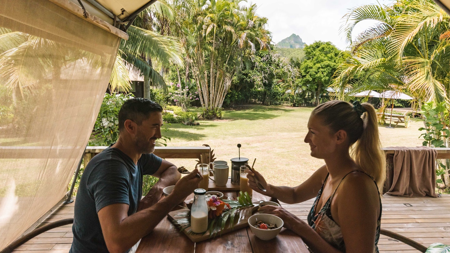 A couple having breakfast at Ikurangi Eco Resort in the Cook Islands.