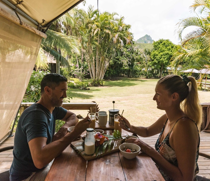 A couple having breakfast at Ikurangi Eco Resort in the Cook Islands.