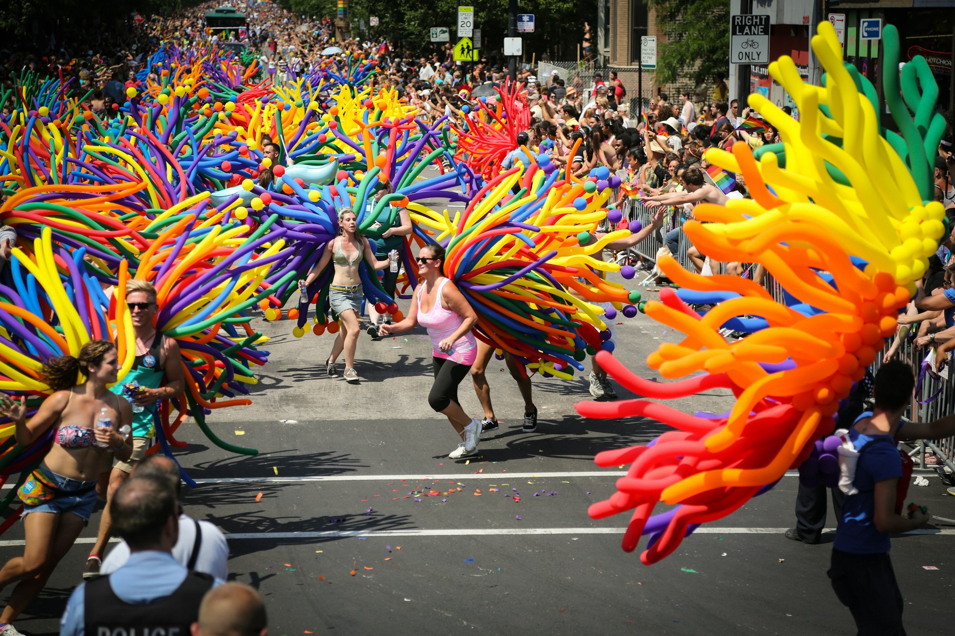 Participants with colourful balloons on their backs run through the streets at the annual Gay Pride parad