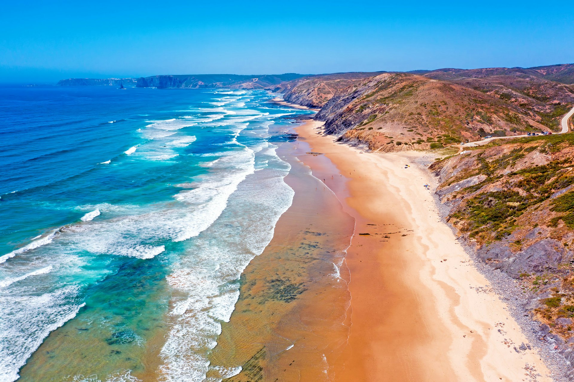 Aerial view of ocean waves crashing on a beach