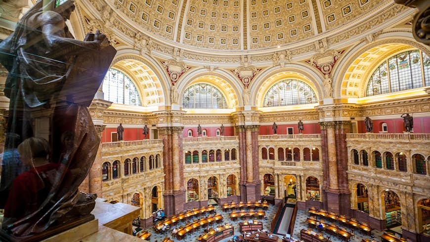 A vast reading room in the Library of Congress, with tables laid out in a circular format