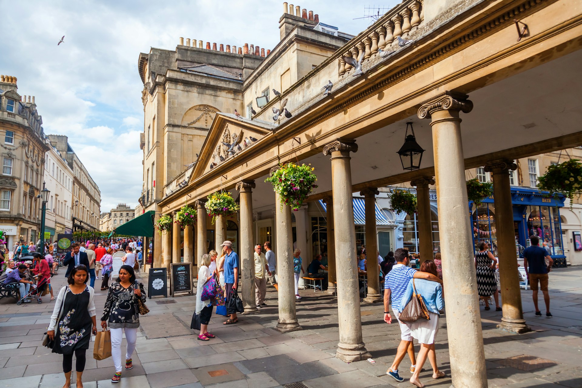 Visitors walk past the Grand Pump Room in Bath, Somerset