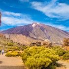 The Roque Cinchado rock formation with the Pico del Teide mountain volcano summit in the background. Tenerife.