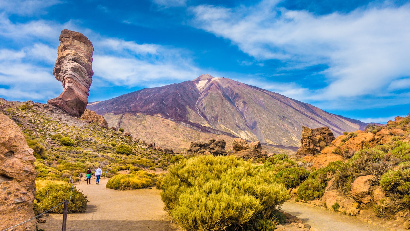 The Roque Cinchado rock formation with the Pico del Teide mountain volcano summit in the background. Tenerife.