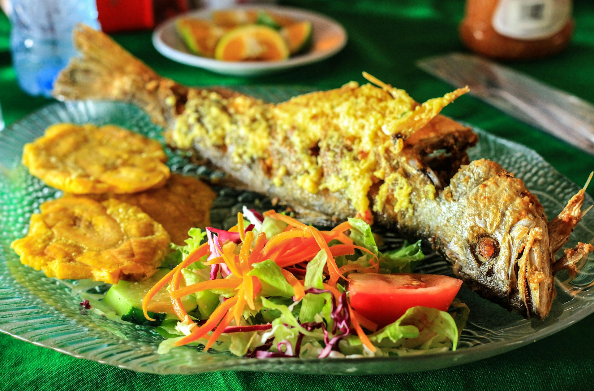 Fried fish with plantains and salad, a Puerto Rican staple