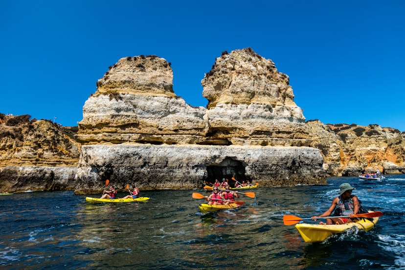 Lagos, Portugal, August 18, 2017: Kayak boats exploring the Ponta da Piedade rock formations near Lagos, Portugal
