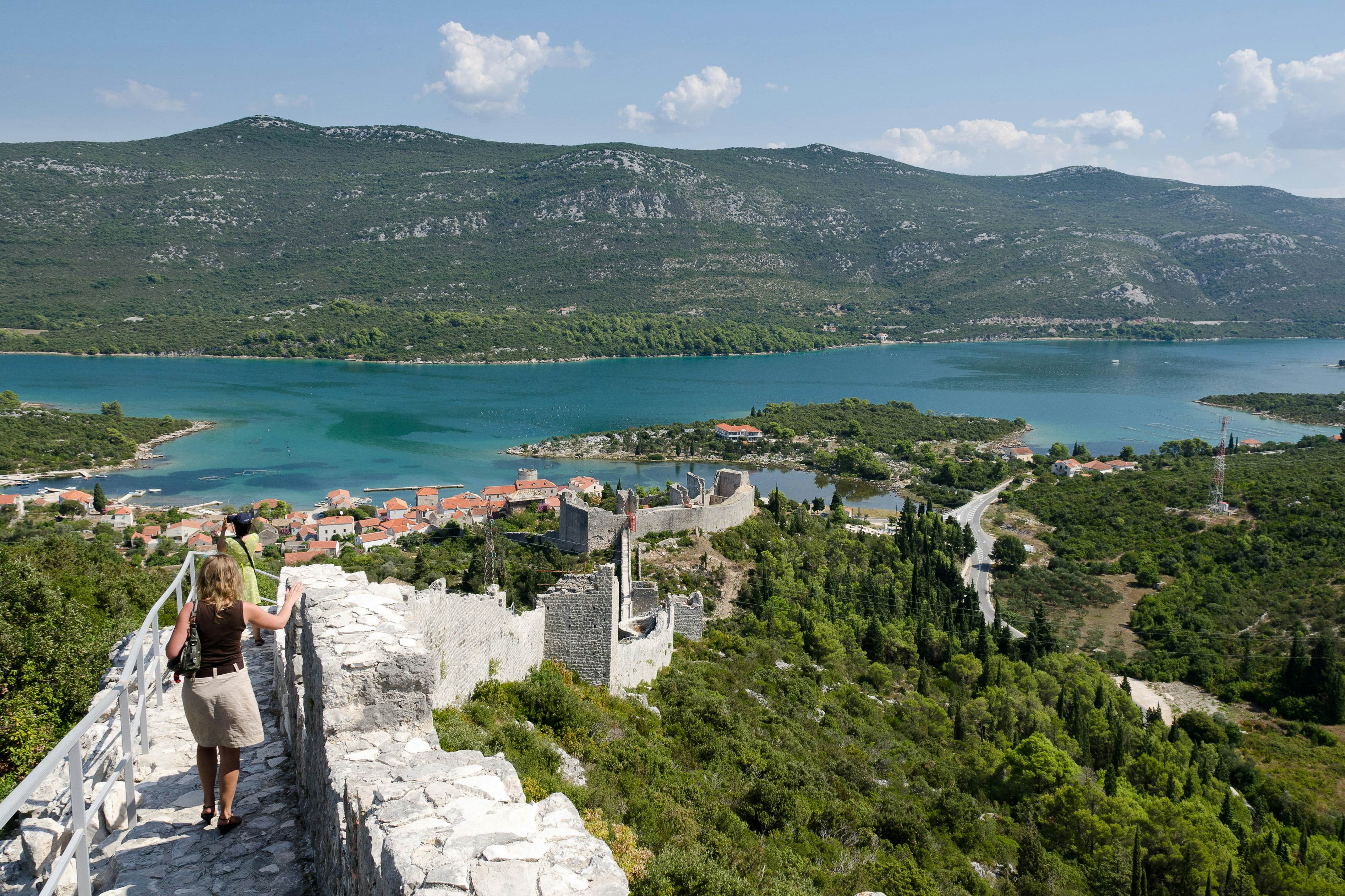 People walking along the defence wall in Ston in Croatia