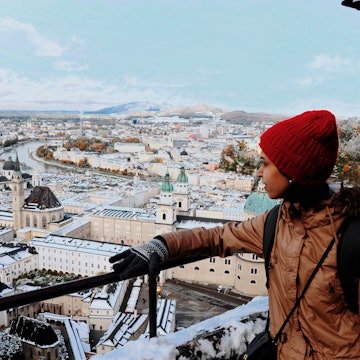 Young woman loooking at the view of Salzburg