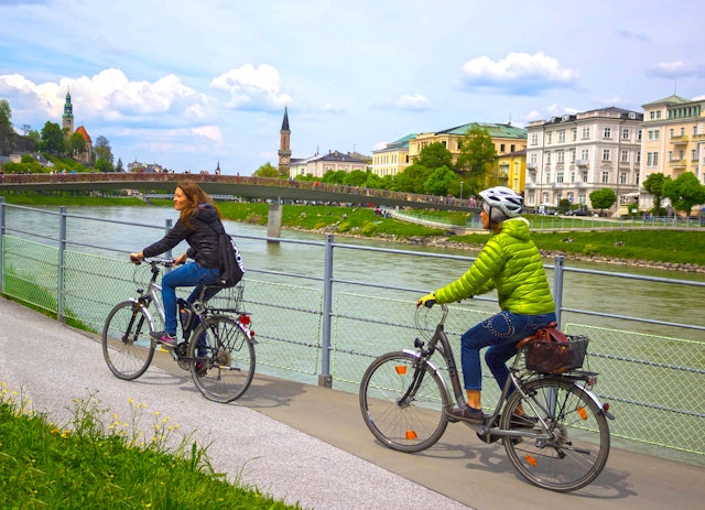 Cyclist on the embankment in Salzburg