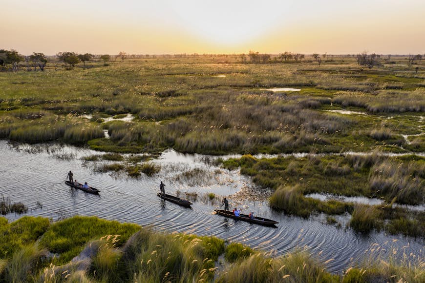 Visitors in mokoro canoes on the Okavango Delta in Botswana