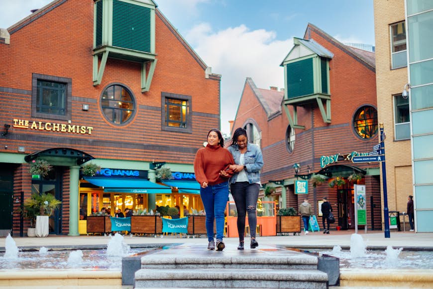 Two women shopping at Brindley Place in Birmingham UK