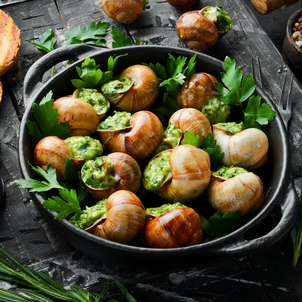 "Escargots de Bourgogne" - baked snails with garlic, butter and basil. French traditional food.