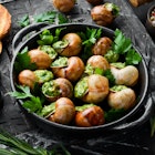 "Escargots de Bourgogne" - baked snails with garlic, butter and basil. French traditional food.