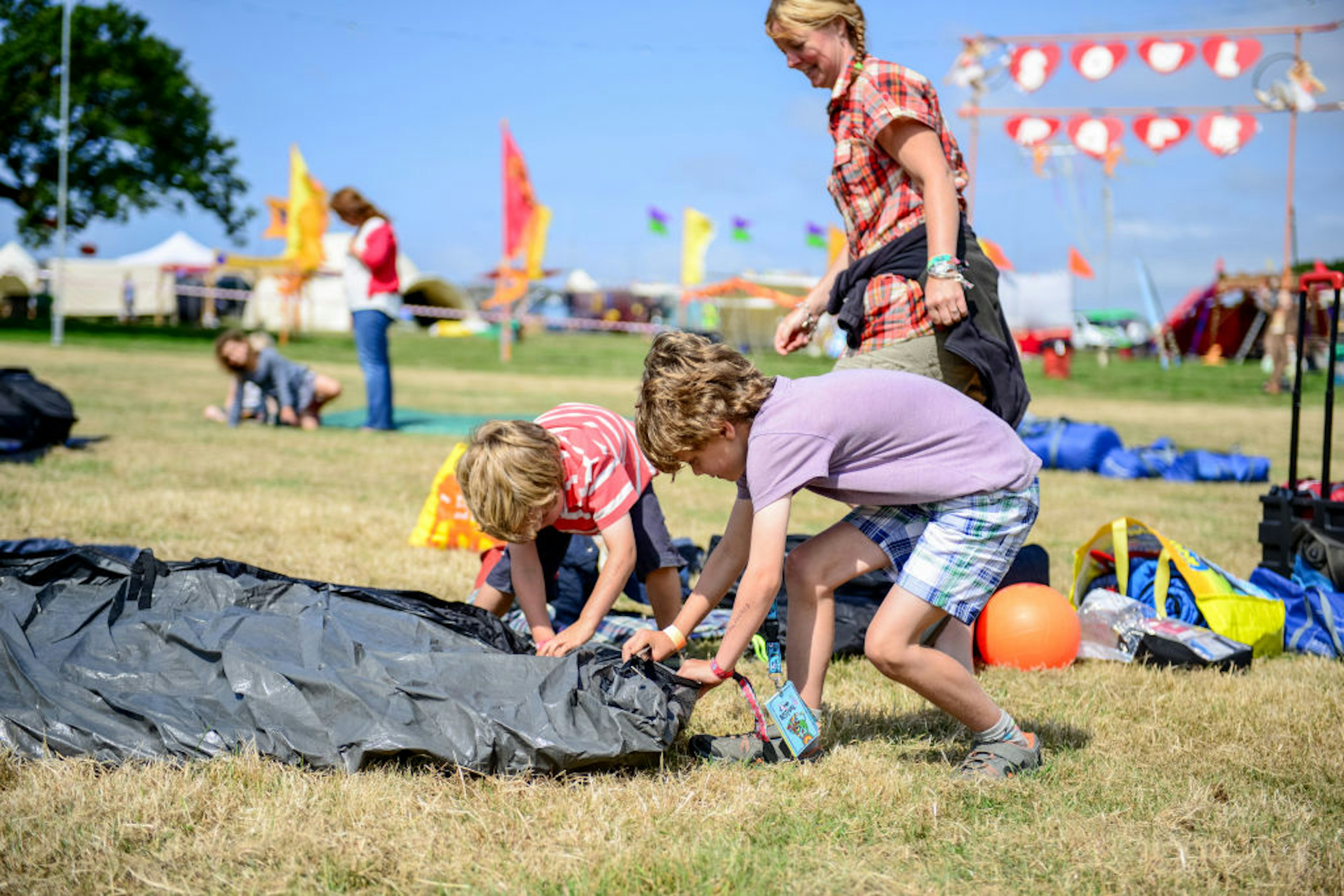 Festival goers set up in the campsite on the first day of Camp Bestival