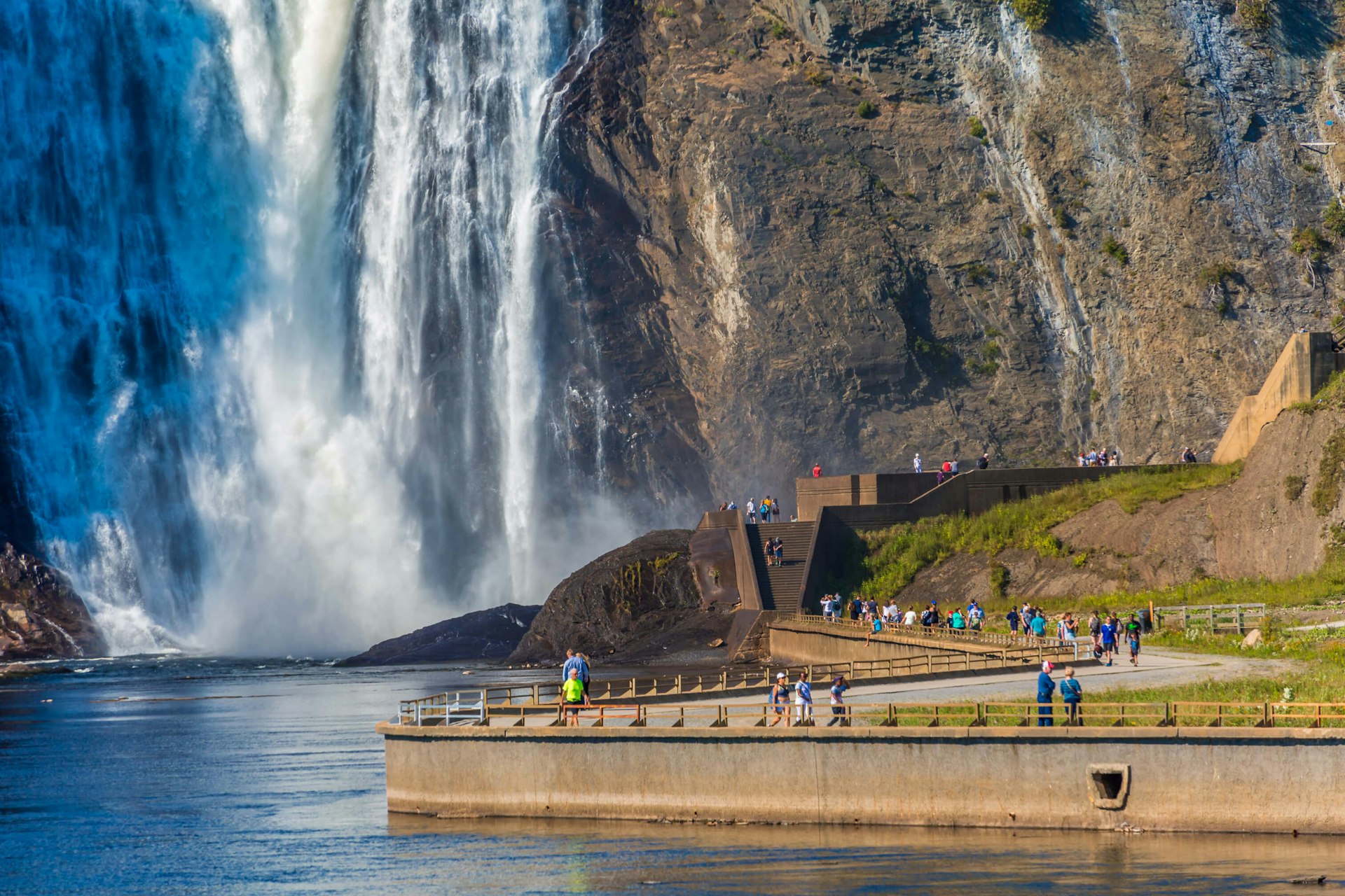 Tourists walking along the path toward Montmorency Falls