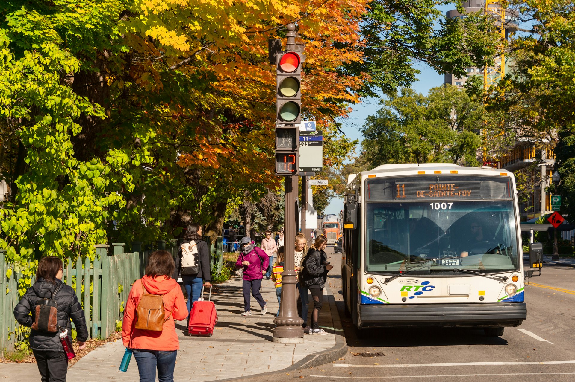 A bus taking on passengers in the fall on Grande Allée, Québec City, Québec, Canada 