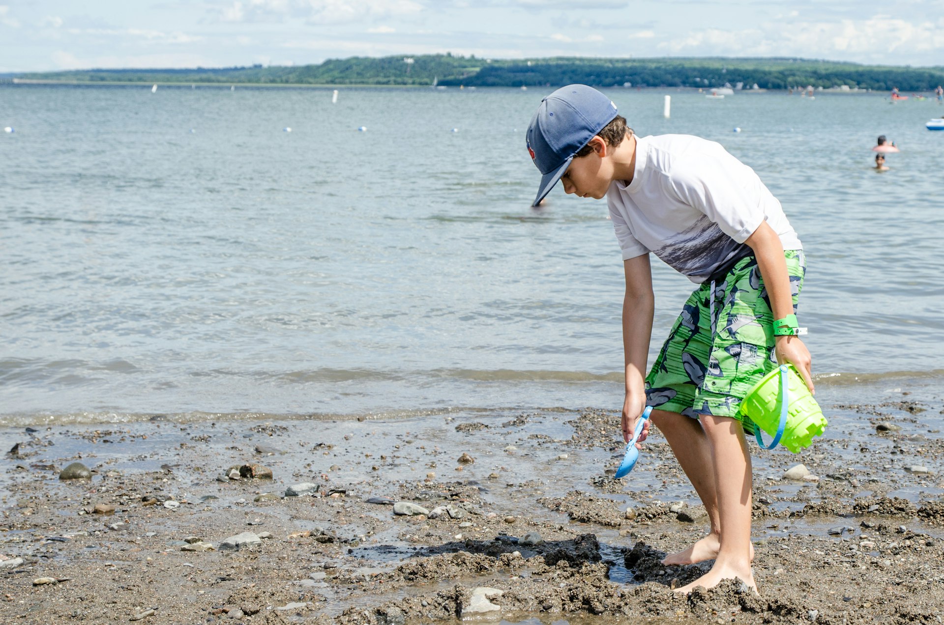 A boy plays on the beach close to the St-Lawrence River in summer, Québec City, Québec, Canada