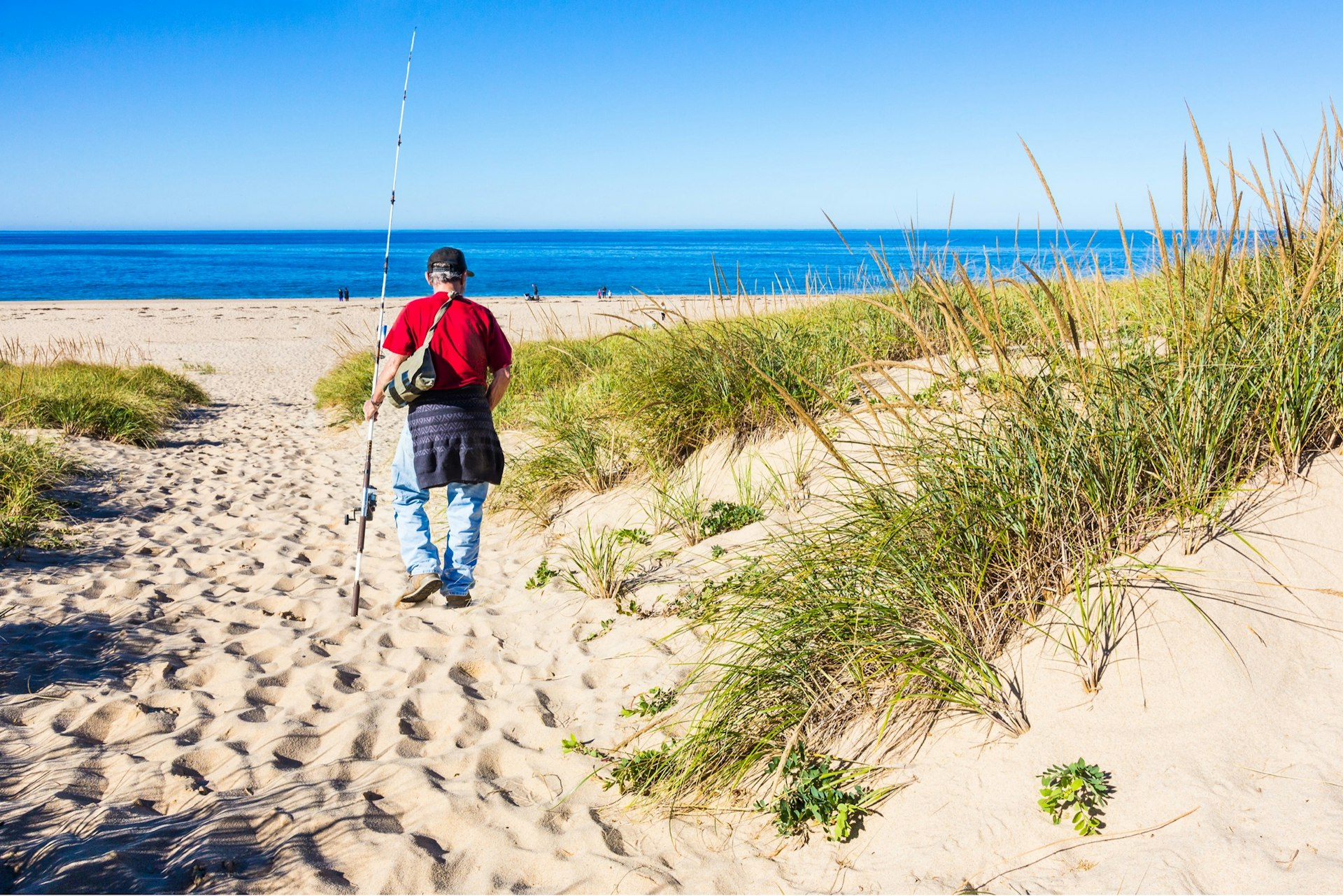 This fisherman heads to the water at the Cape Cod Natural Seashore to fish. 