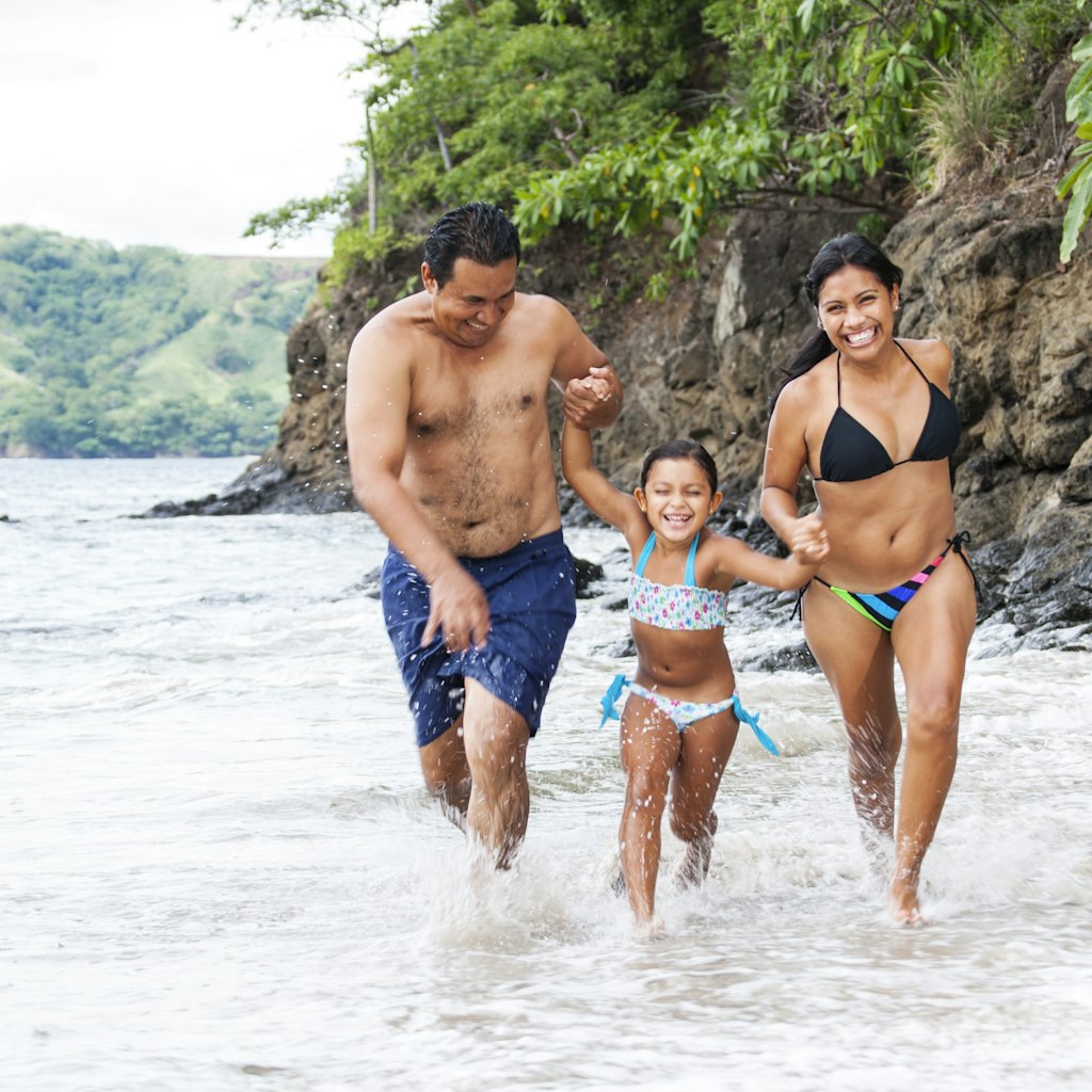 A family playing in the surf on a Costa Rican beach