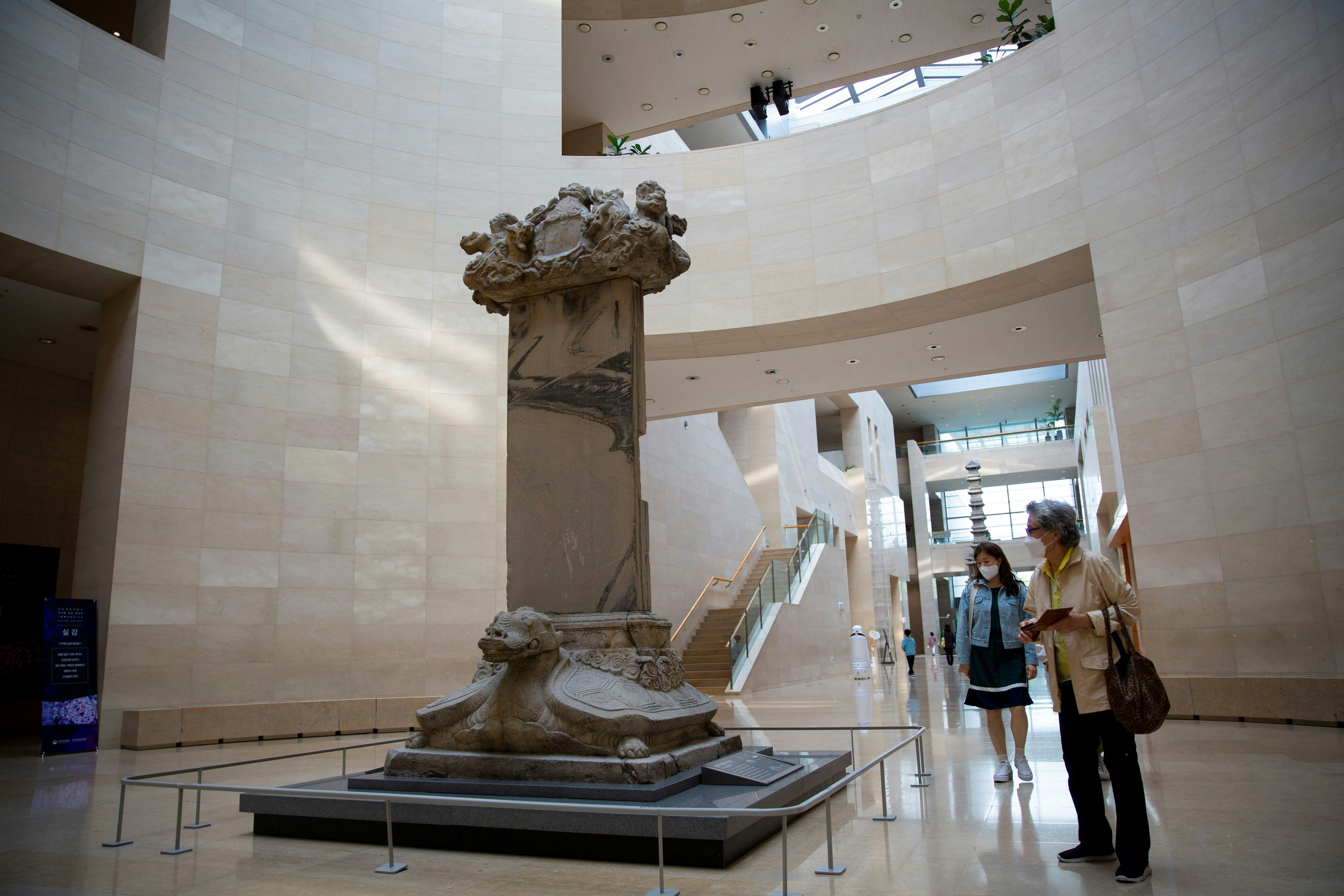 Visitors look at artifacts at the National Museum of Korea in Seoul, South Korea