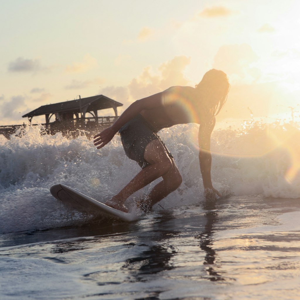 Surfing during morning sunrise