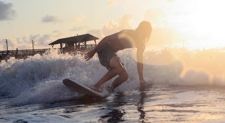 Surfing during morning sunrise