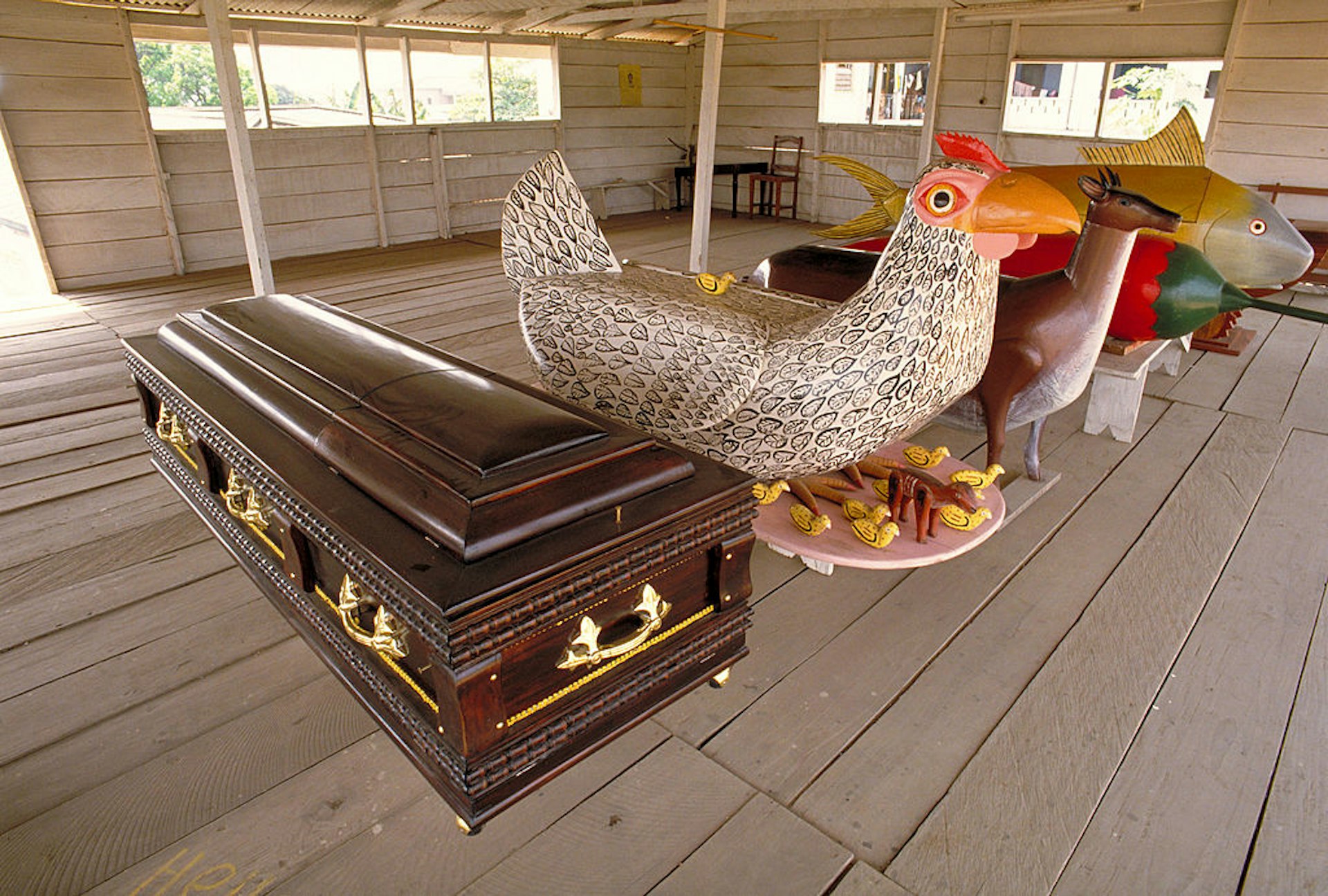 Whimsical "fantasy coffins" made in the form of animals and material objects in the studio of an artisan in Teshie-Nungua, Ghana, West Africa