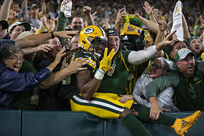 GREEN BAY, WI - SEPTEMBER 20:  Aaron Jones #33 of the Green Bay Packers celebrates with fans after scoring a touchdown during a game against the Detroit Lions at Lambeau Field on September 20, 2021 in Green Bay, Wisconsin.  The Packers defeated the Lions 35-17.  (Photo by Wesley Hitt/Getty Images)