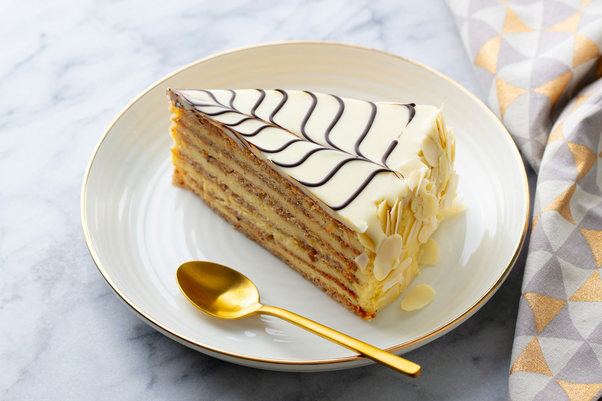 Traditional Hungarian Esterhazy cake, torte. Marble background. Close up.