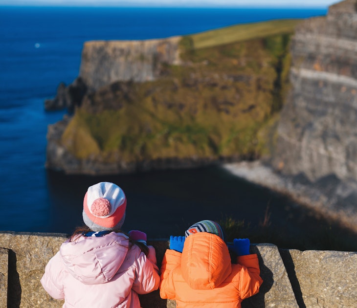 boy and girl looking at cliff of moher in ireland; Shutterstock ID 1603639525; your: Brian Healy; gl: 65050; netsuite: Lonely Planet Online Editorial; full: Ireland with kids