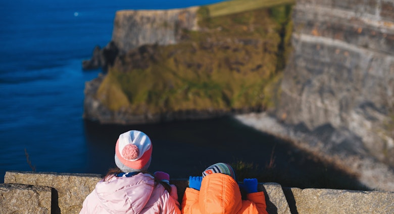 boy and girl looking at cliff of moher in ireland; Shutterstock ID 1603639525; your: Brian Healy; gl: 65050; netsuite: Lonely Planet Online Editorial; full: Ireland with kids