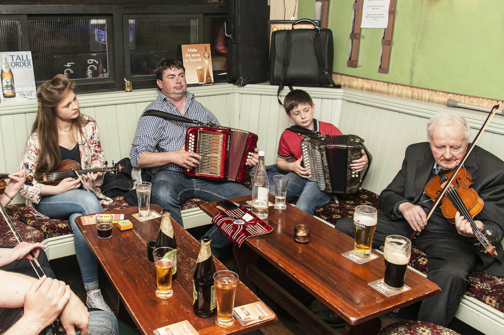 A group of Irish musicians of all ages play traditional Irish music in a pub in Lismore, County Waterford, Ireland