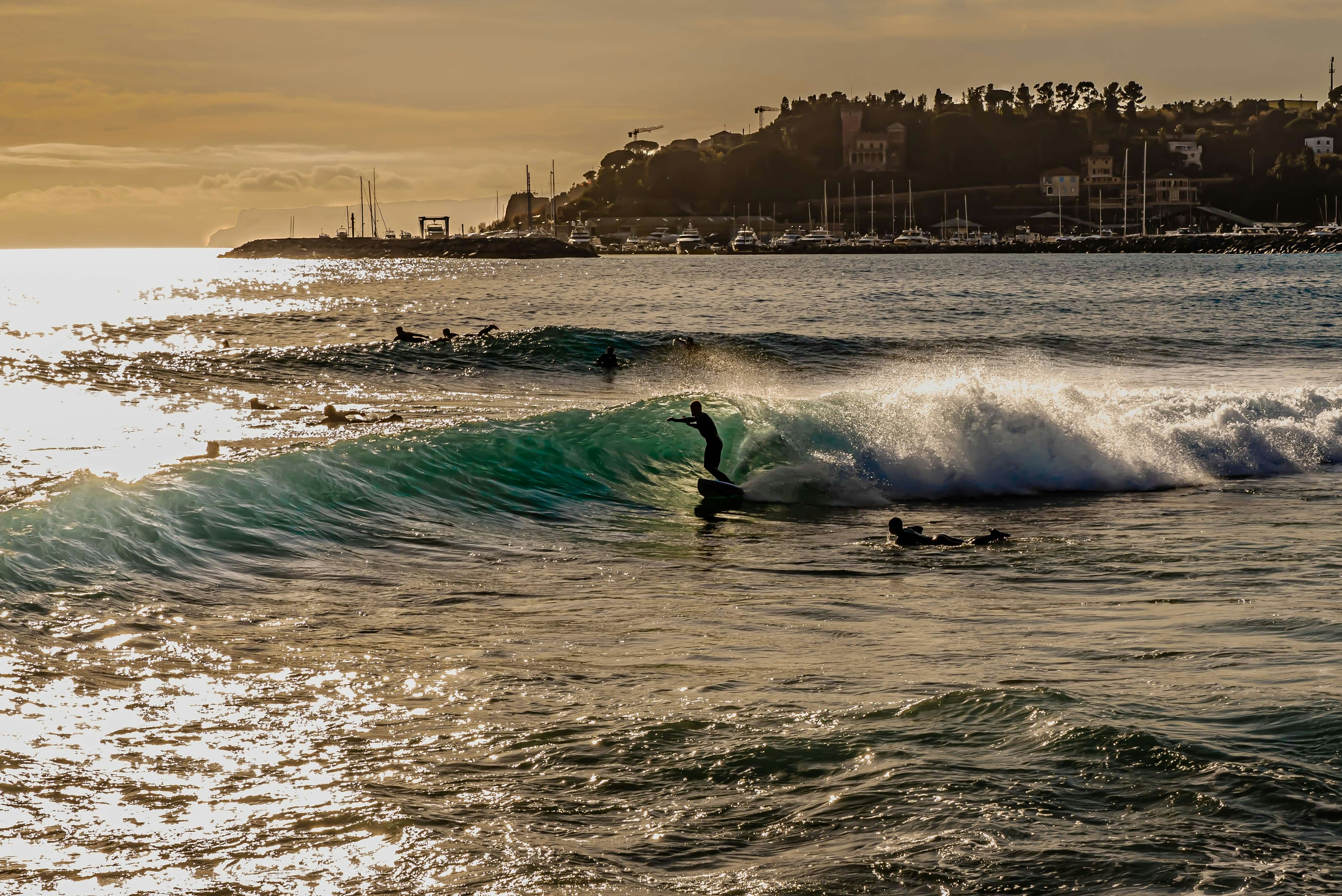 People surfing at Varazze, a municipality in the Beigua park, overlooking the Ligurian Sea