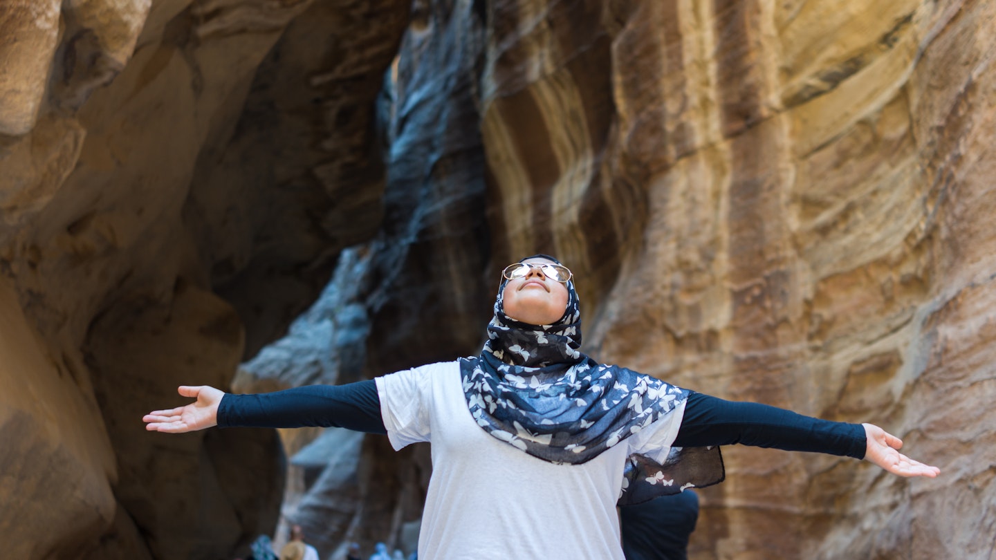 Tourist girl with hijab visiting Petra in Jordan; Shutterstock ID 619203992; your: Brian Healy; gl: 65050; netsuite: Lonely Planet Online Editorial; full: Getting the most out of the Jordan Pass