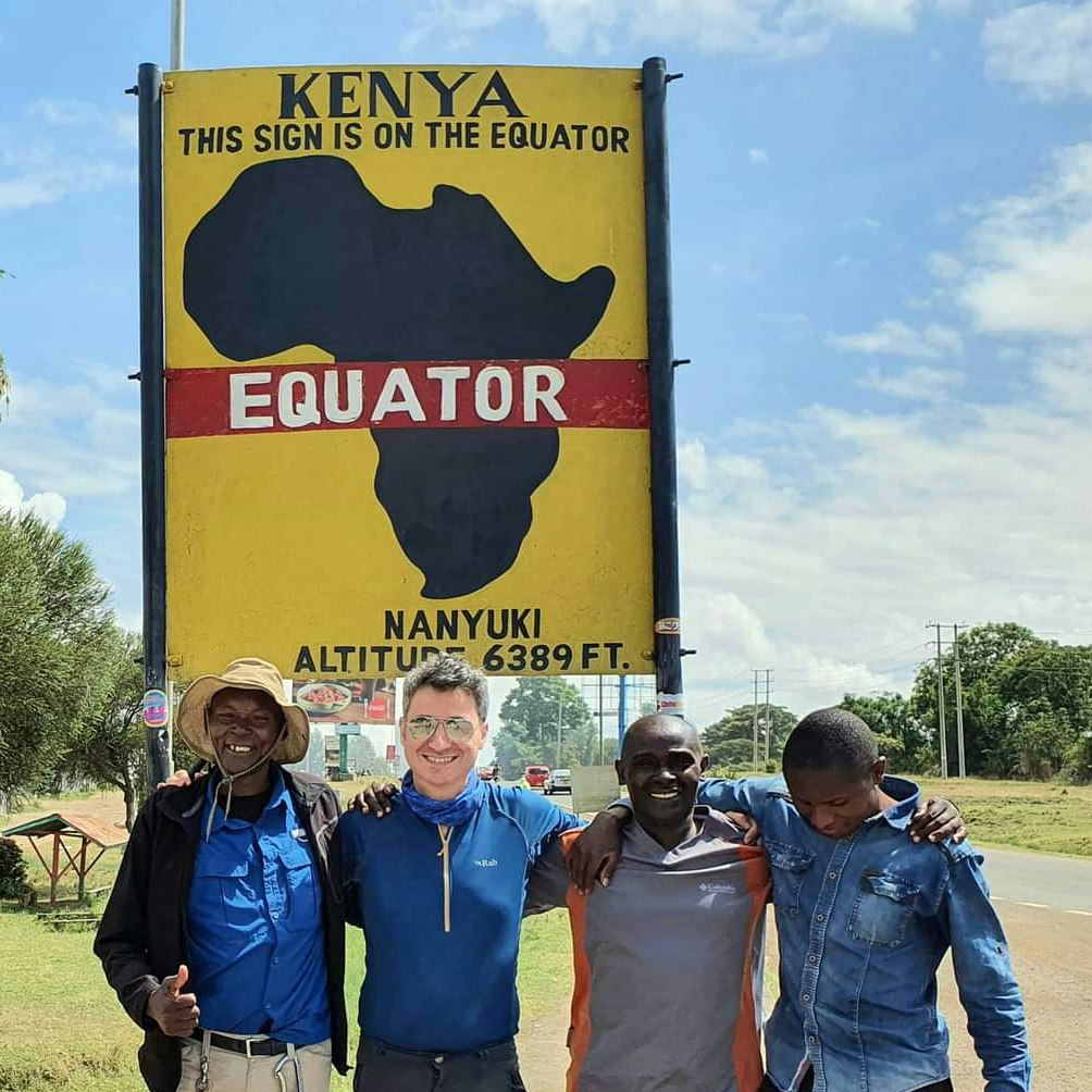 Writer Peter Elia and guides Joshua, Benson, and Samir at the the Equator line on Mt Kenya