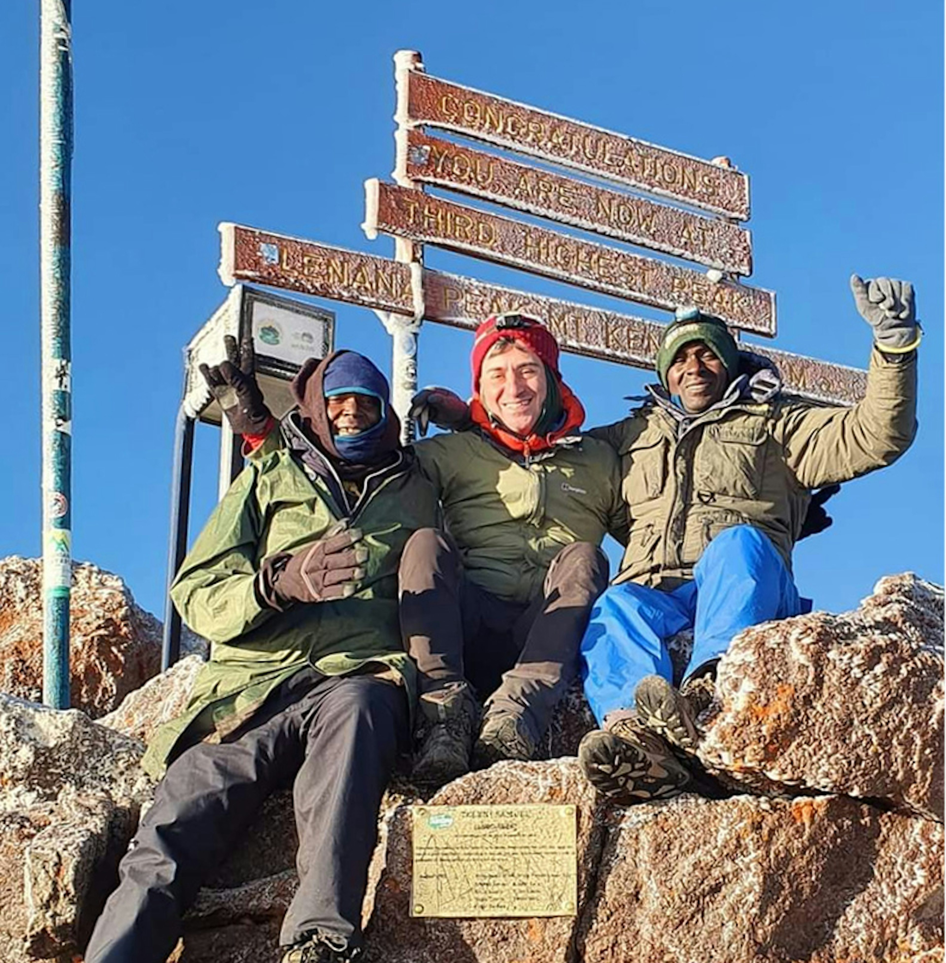 Writer Peter Elia and guides Joshua and Benson at the summit of Mt Kenya