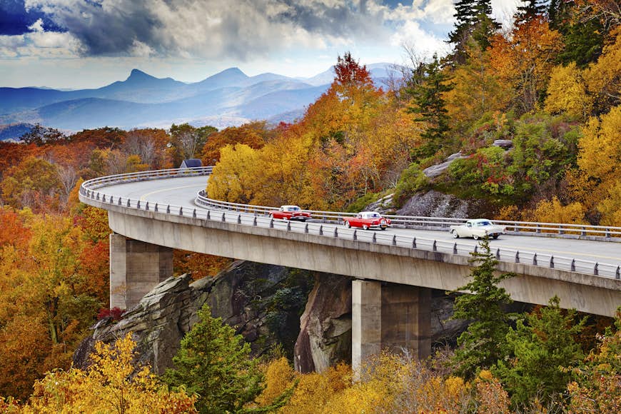 Classic cars on Linn Cove Viaduct in fall, Blue Ridge Parkway Scenic Drive