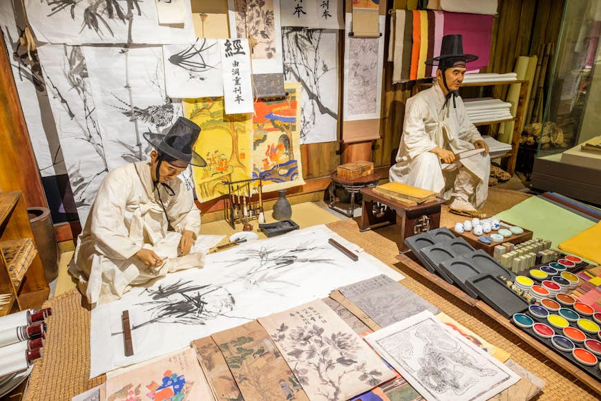 Two figures create art in the Seoul Museum of History in Seoul, South Korea