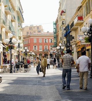 A busy street in Nice, France with people browsing street stalls 