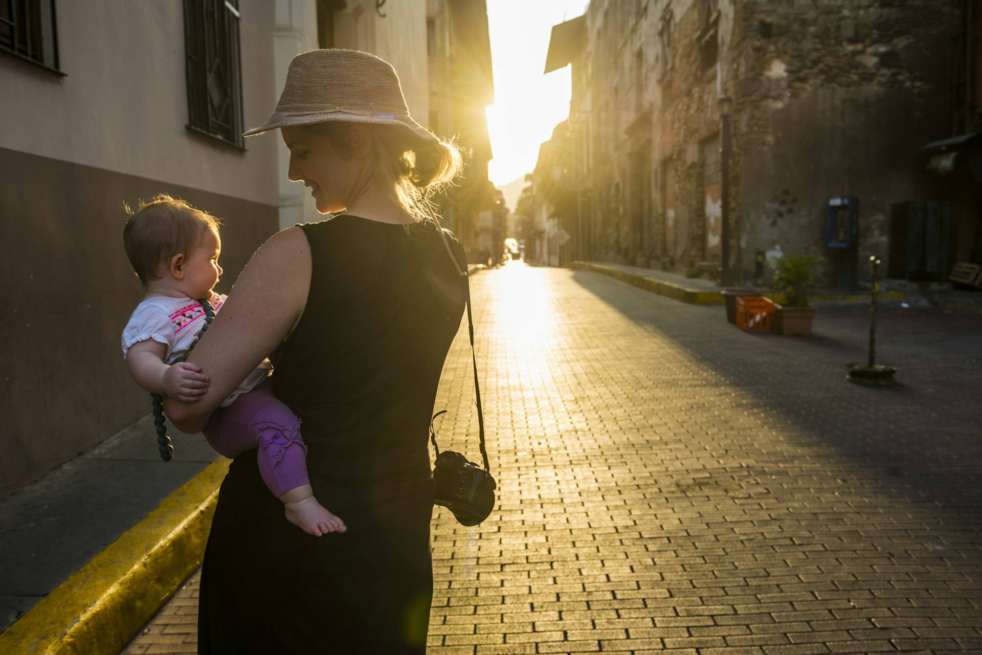Panama, mother and baby girl visiting Panama City at sunset