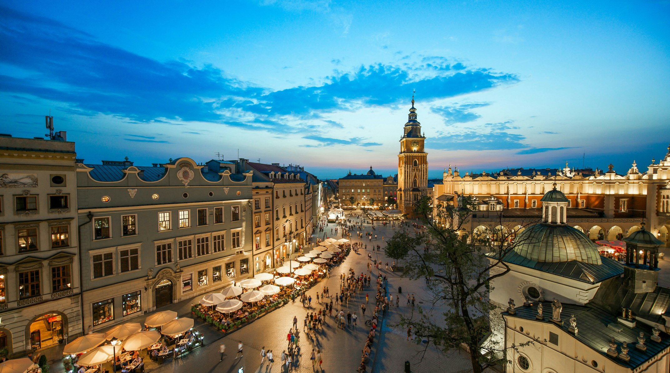 Evening in Krakow's Old Town with people heading to restaurants