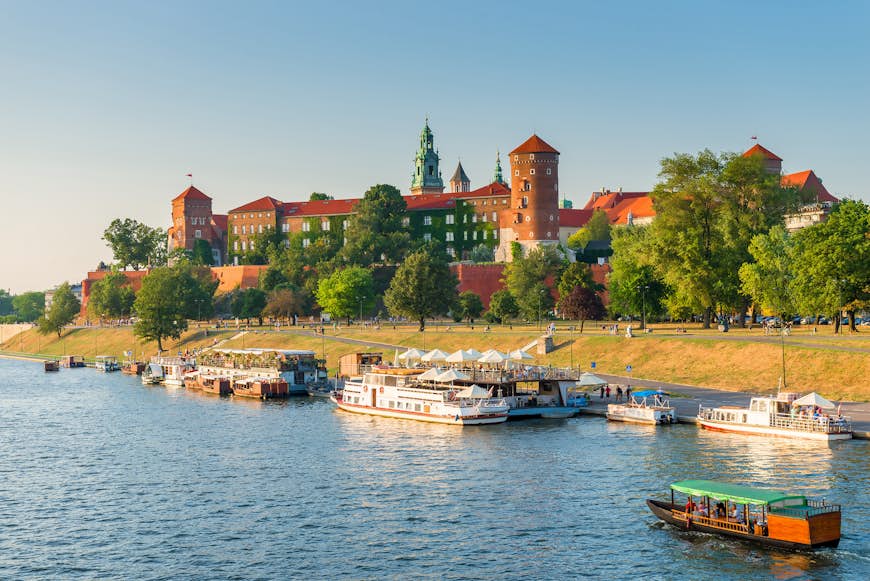 A panoramic view of boats in the Vistula River by Wawel Castle, Kraków, Poland