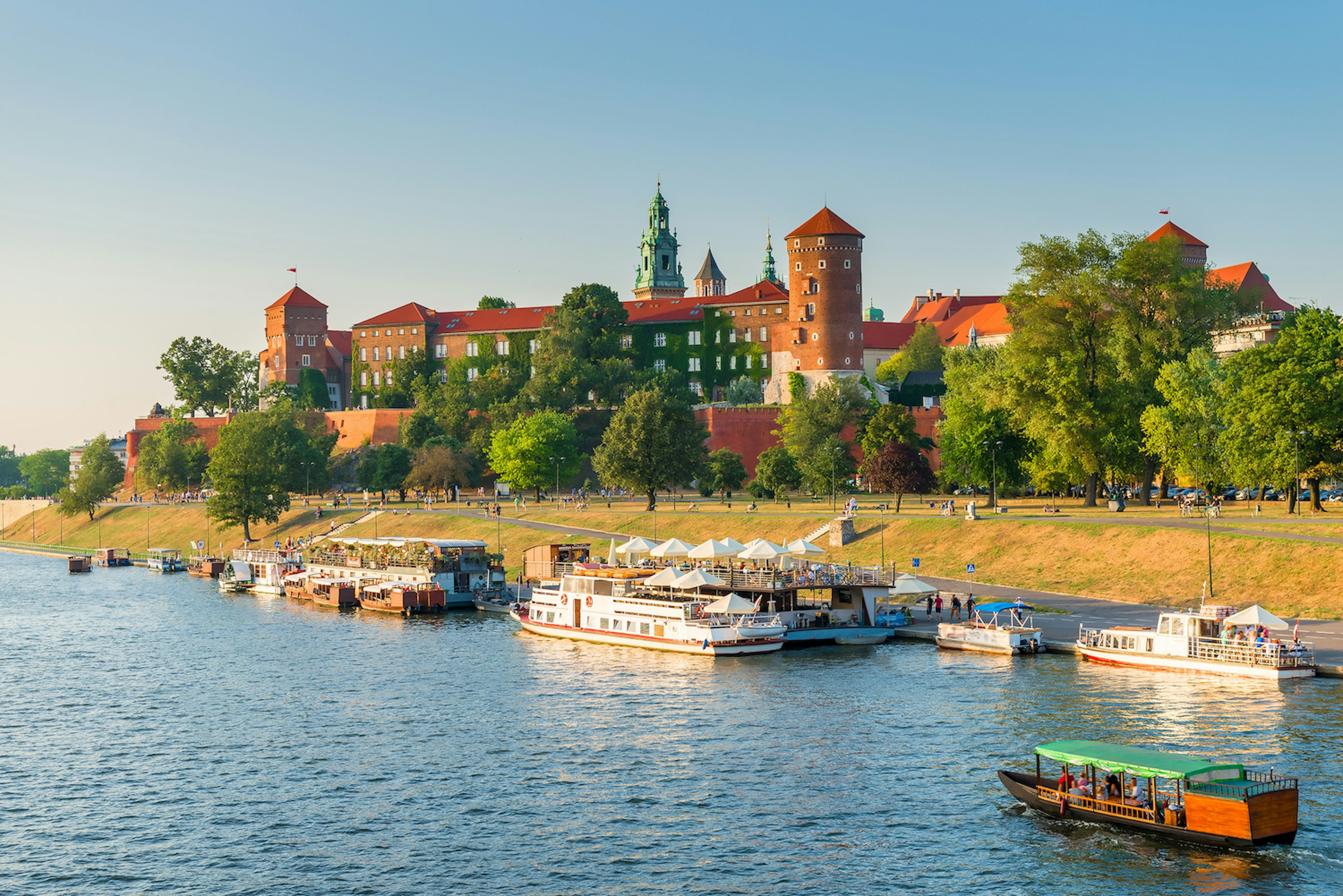 A panoramic view of boats in the Vistula River by Wawel Castle, Kraków, Poland