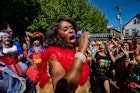 Entertainer Qya Cristal holds a chrome microphone during performance at a Pride rally in Provincetown, Massachusetts. 
