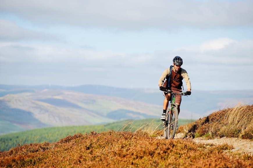 A mountain biker follows a trail in the Scottish borders