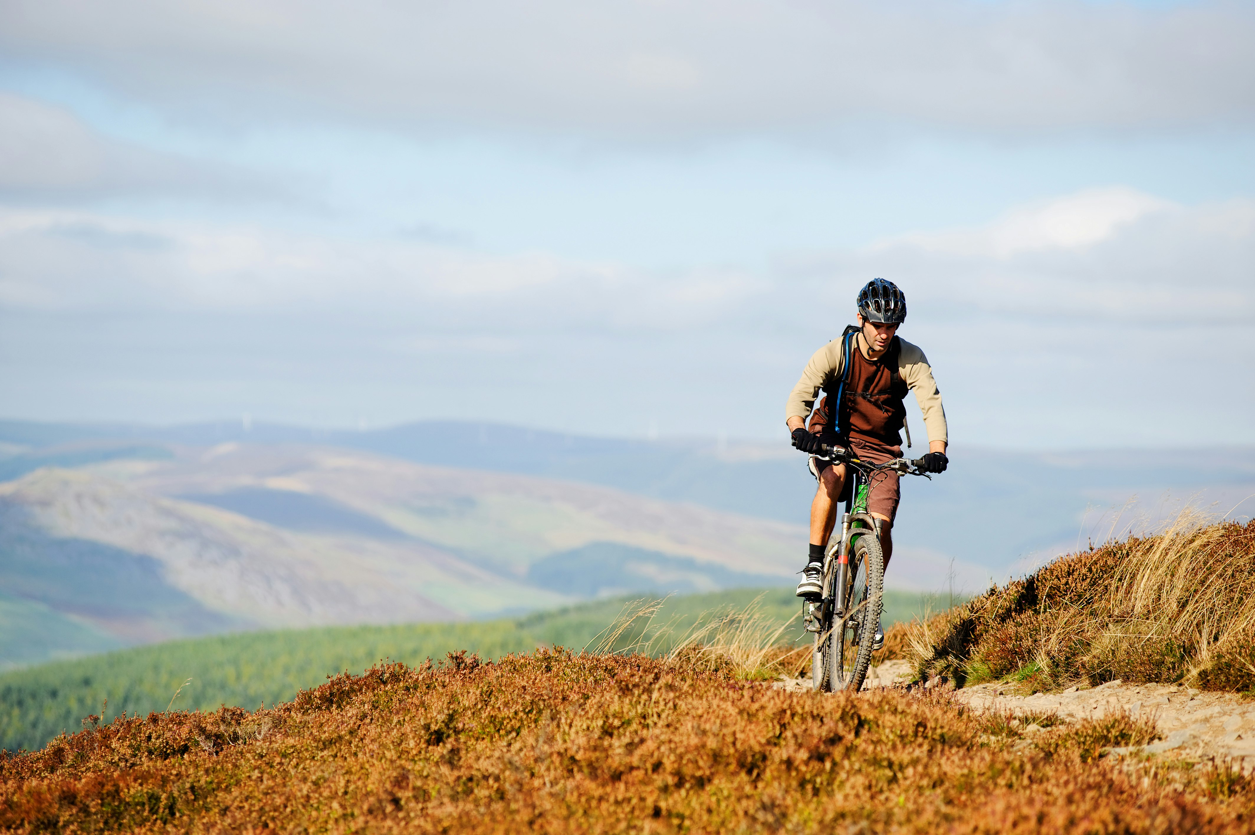 A mountain biker follows a trail in the Scottish borders