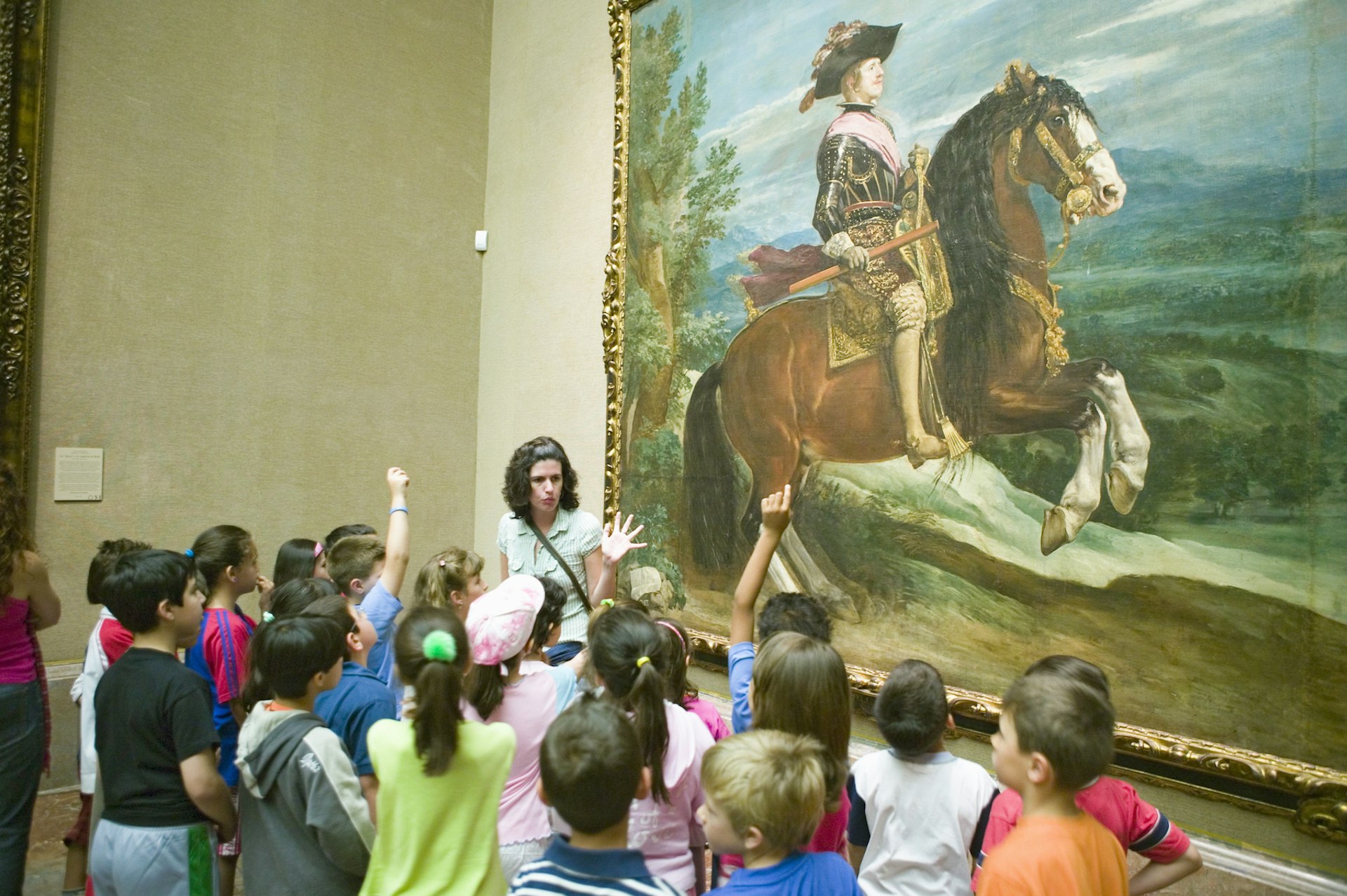 An educator interacts with children in from of "Philip IV on Horseback" by Diego Velázquez at the Museo del Prado, Madrid Spain