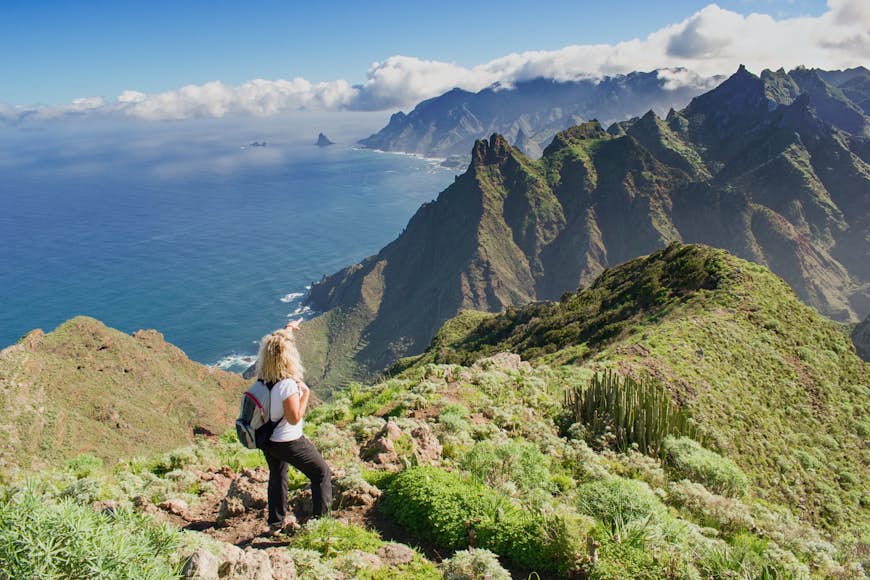 Woman hiker watching beautiful costal scenery in the Anaga region on Tenerife