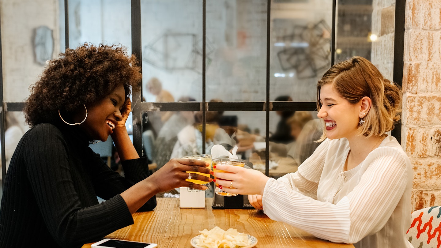 Two Girlfriends In A Restaurant