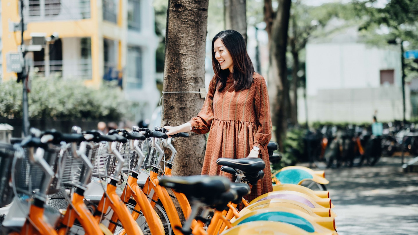 Beautiful Asian girl renting shared bicycle in city centre - stock photo
Beautiful Asian girl renting shared bicycle in city centre